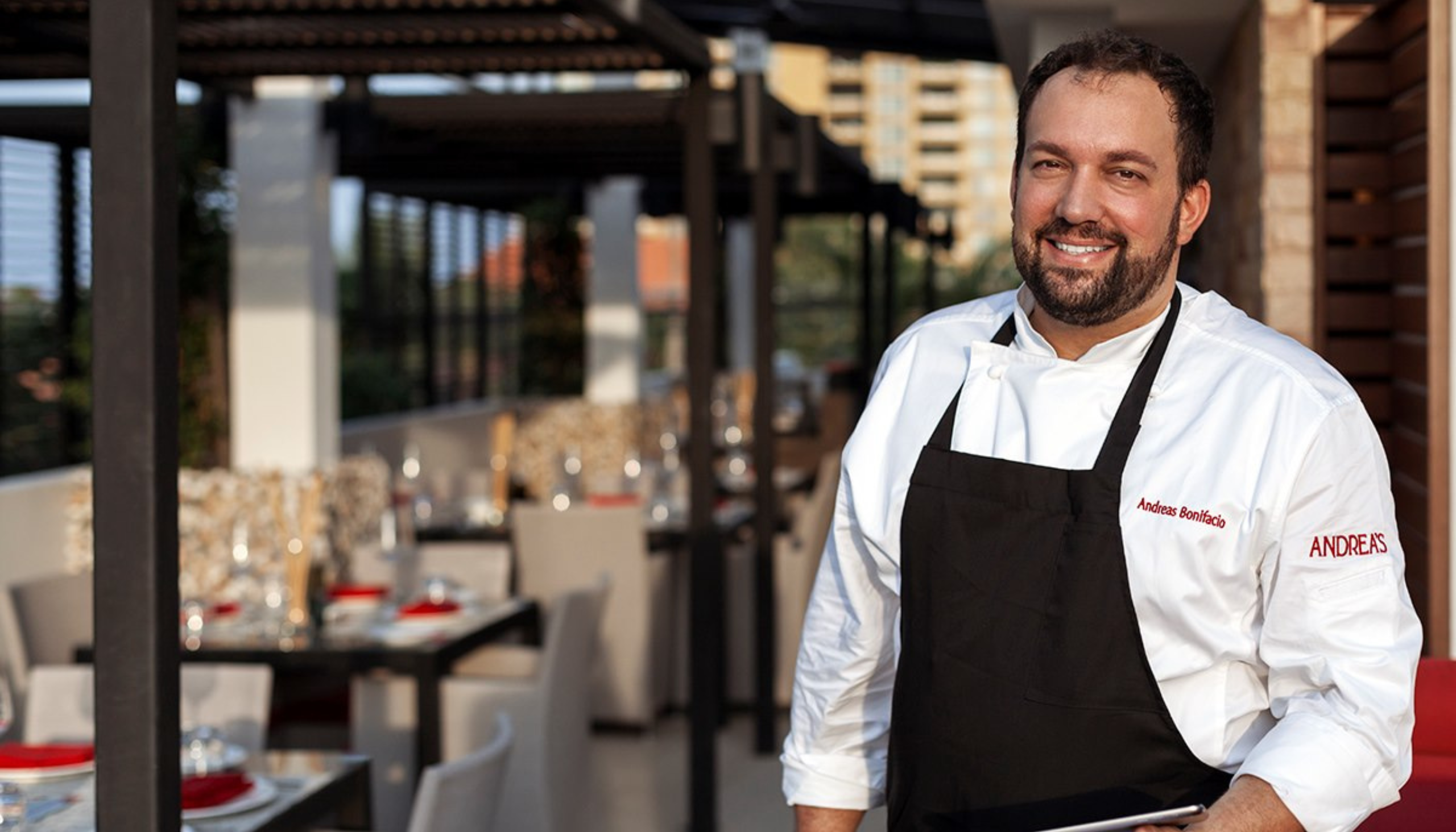 Chef Andreas Bonifacio on the restaurant terrace in his chef whites